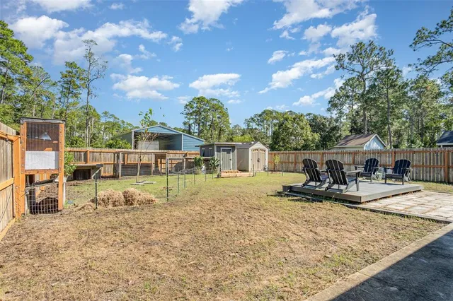 a view of a house with backyard porch and sitting area