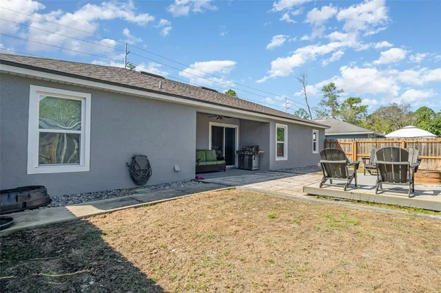 a front view of house with yard outdoor seating and barbeque oven