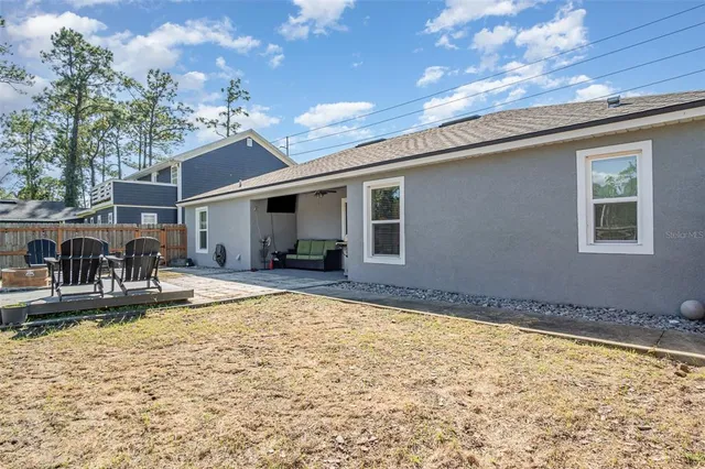 a view of a house with swimming pool and sitting area