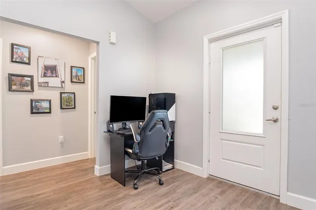 a view of workspace with wooden floor windows