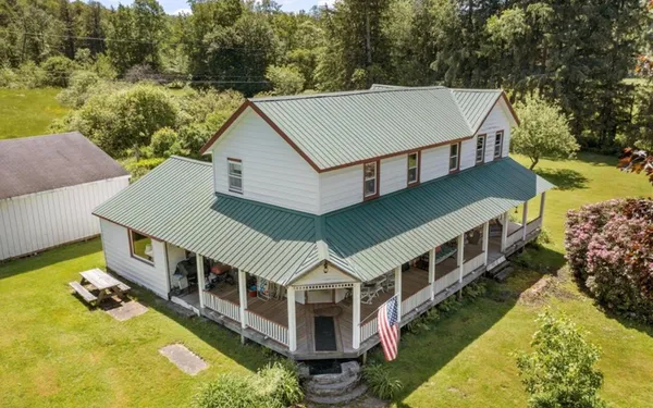 an aerial view of a house with a yard