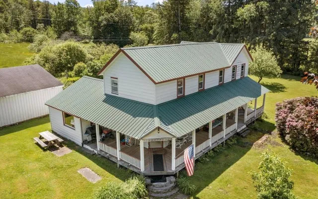 an aerial view of a house with a yard