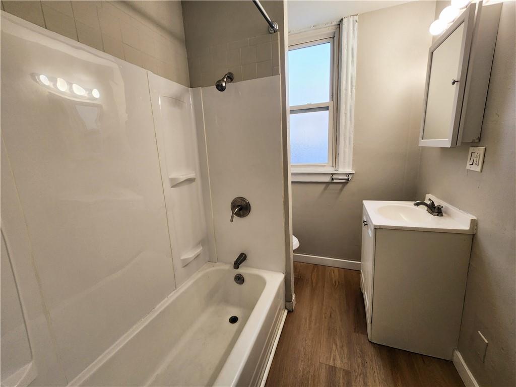 124 Cutler Street McKees Rocks, PA 15136 - Photo 5 of 9 a bathroom with a tub a sink and mirror