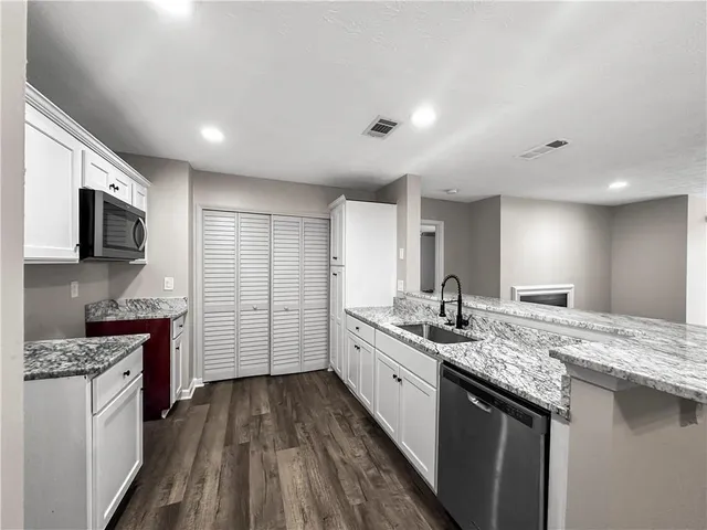 a kitchen with a sink stove and refrigerator