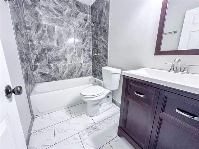 a bathroom with a toilet a sink and a bathtub