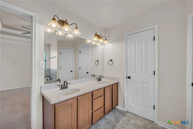 a bathroom with a sink vanity and a mirror