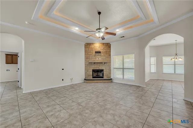 a view of an empty room with a fireplace and a window