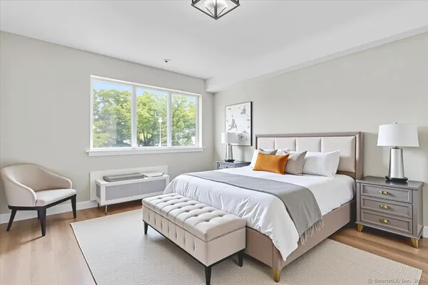 a bedroom with a bed and a chair