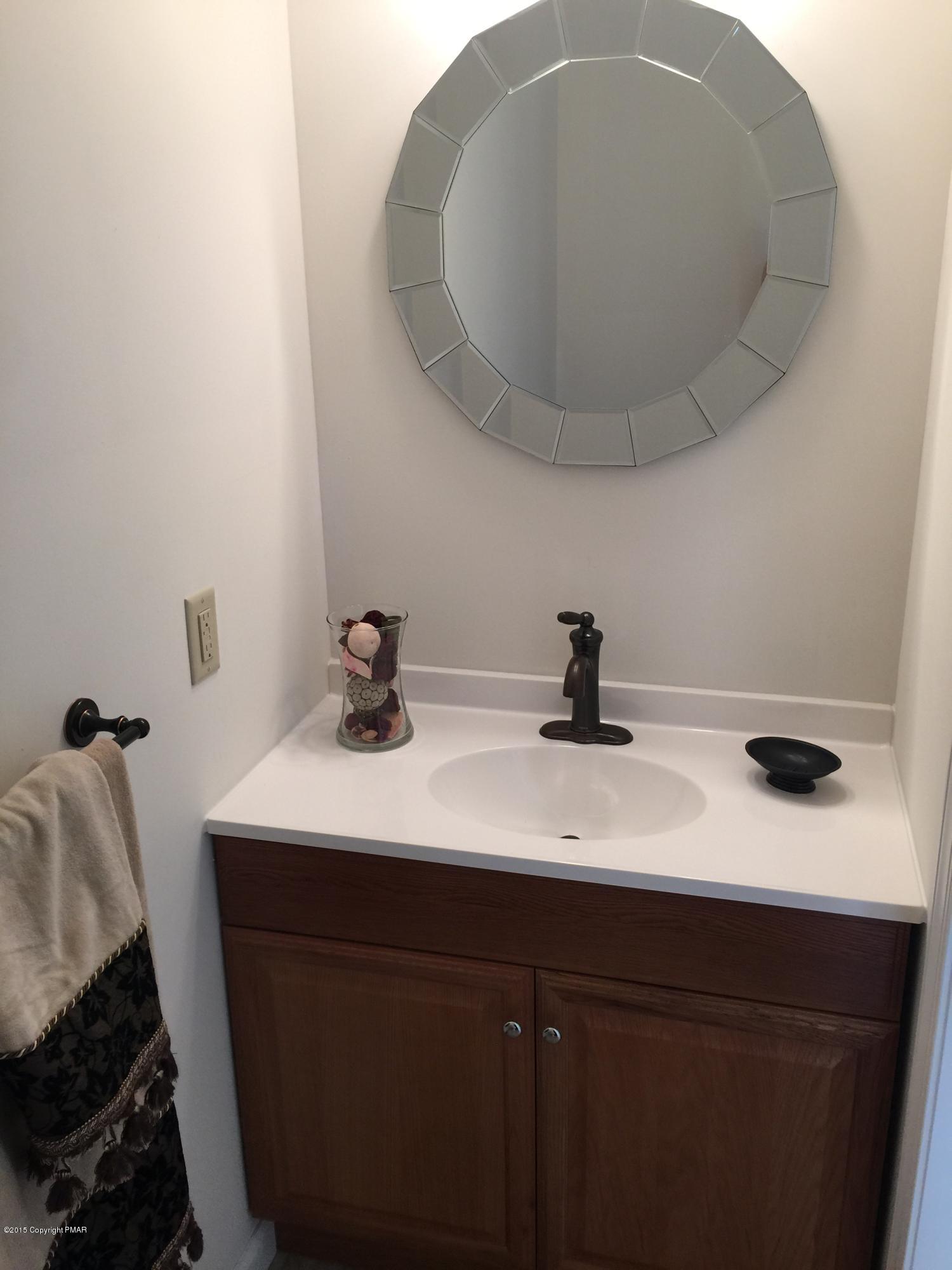 168 Whitetail Road Henryville, PA 18332 - Photo 13 of 28 a bathroom with a sink and a mirror