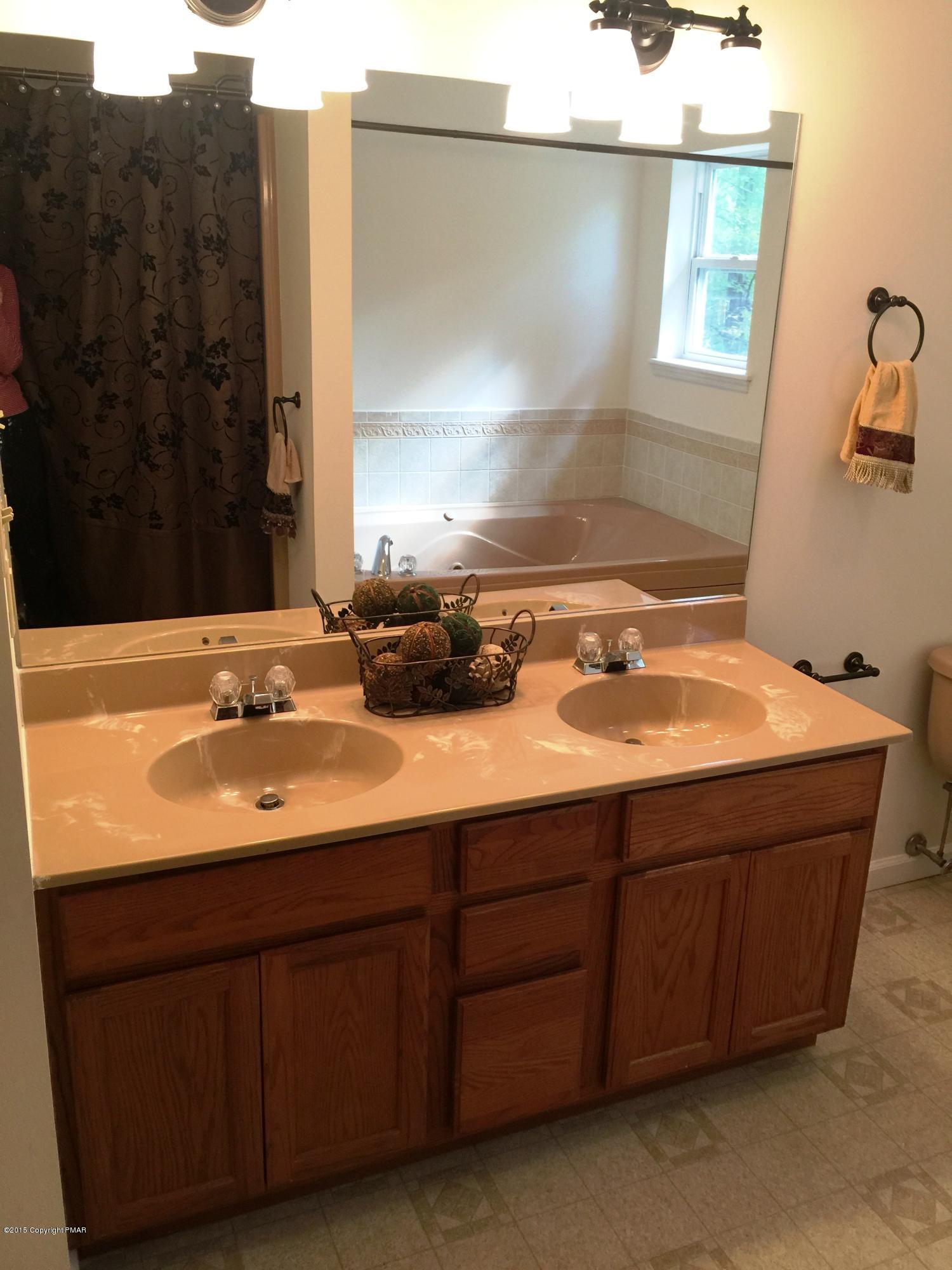 168 Whitetail Road Henryville, PA 18332 - Photo 17 of 28 a bathroom with a sink and a mirror