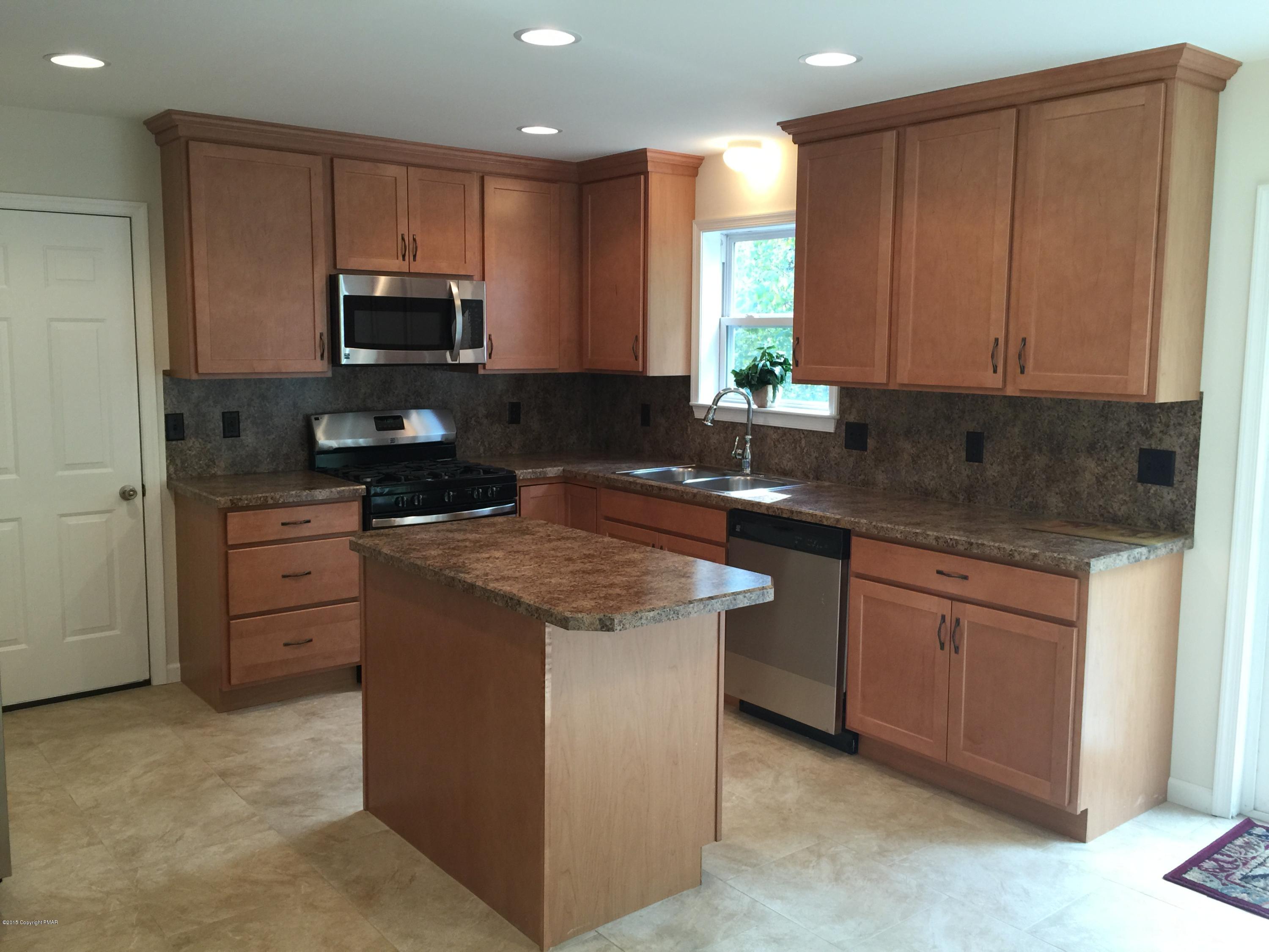 168 Whitetail Road Henryville, PA 18332 - Photo 2 of 28 a kitchen with stainless steel appliances granite countertop a stove a sink and a microwave