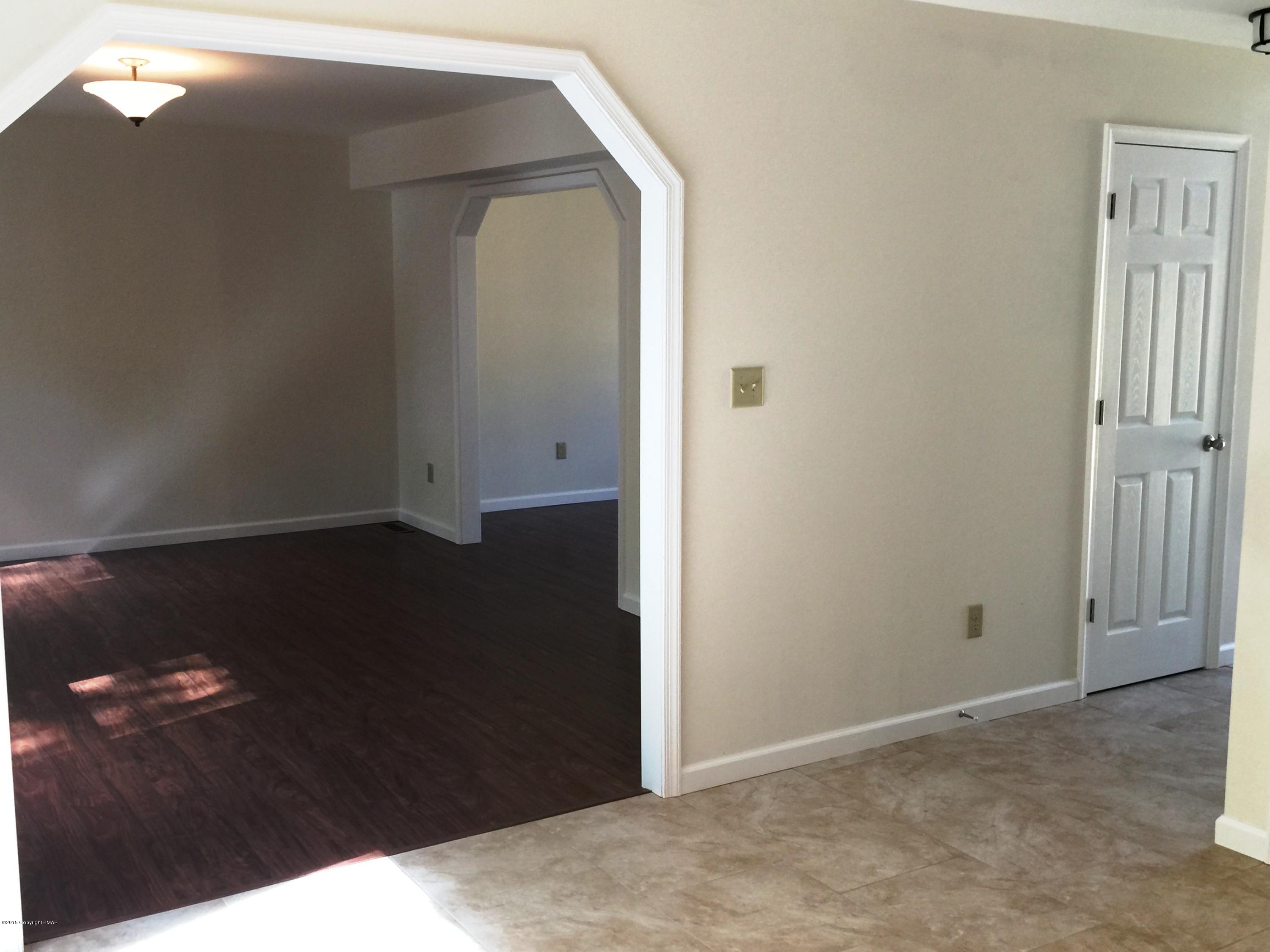 168 Whitetail Road Henryville, PA 18332 - Photo 28 of 28 an empty room with wooden floor and cabinet