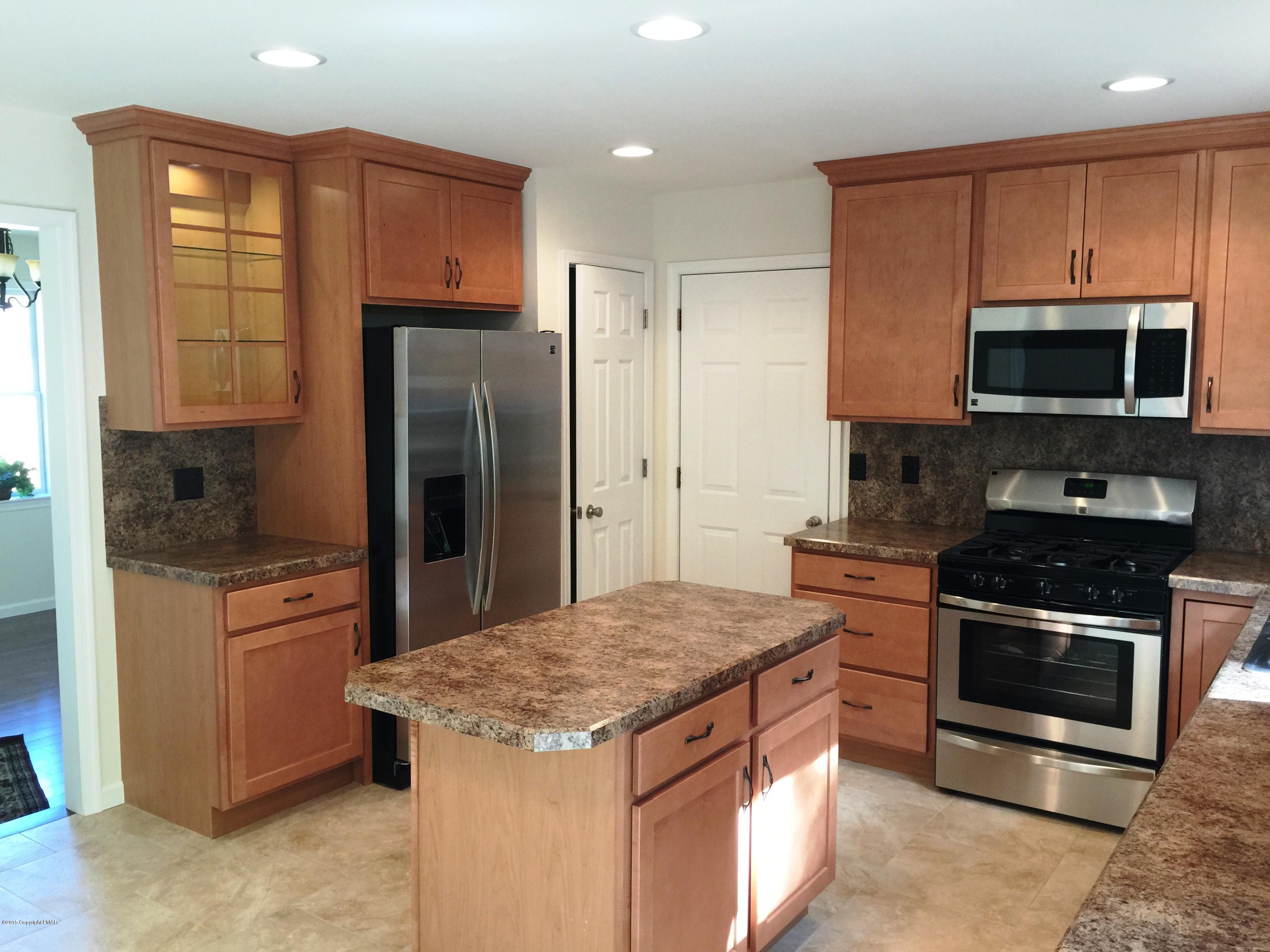 168 Whitetail Road Henryville, PA 18332 - Photo 3 of 28 a kitchen with a stove microwave and refrigerator