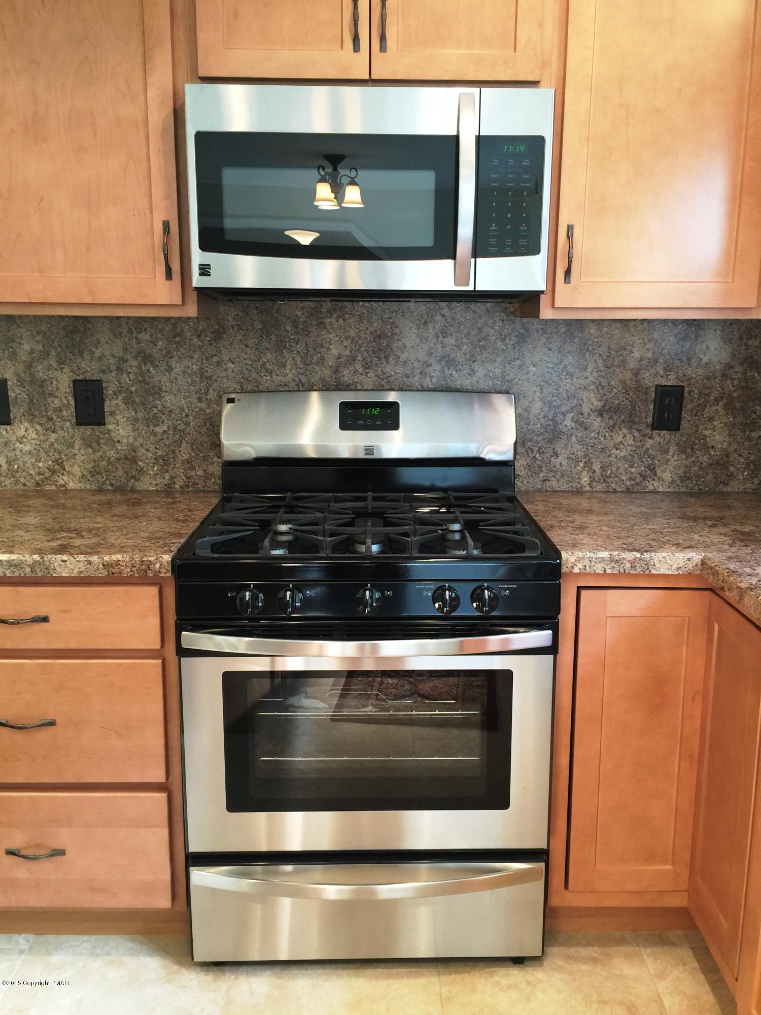 168 Whitetail Road Henryville, PA 18332 - Photo 4 of 28 a stove top oven sitting inside of a kitchen