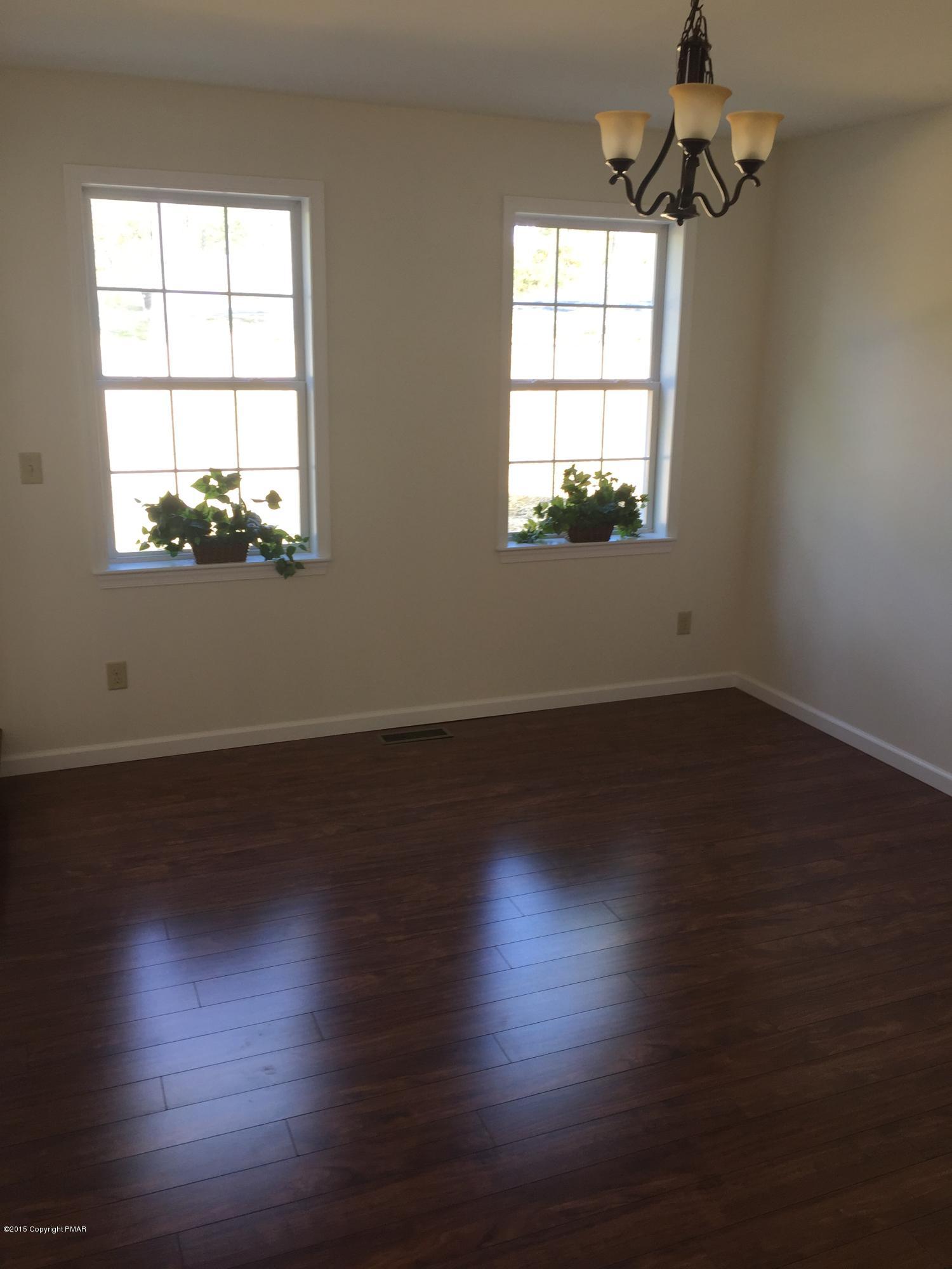 168 Whitetail Road Henryville, PA 18332 - Photo 7 of 28 a view of empty room with wooden floor and fan