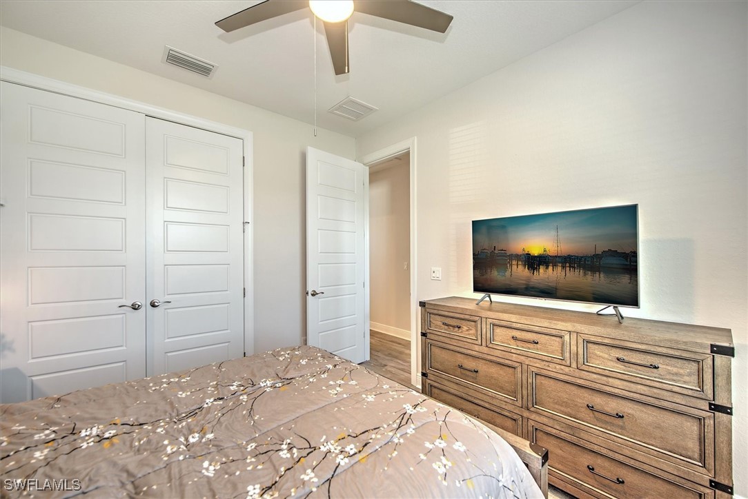 3527 Southwest 4th Lane Cape Coral, FL 33991 - Photo 12 of 18 a bedroom with a bed and a flat screen tv