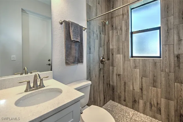 a bathroom with a sink toilet and shower