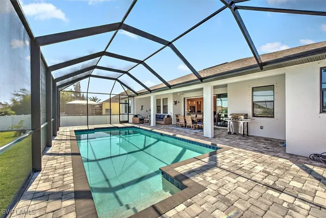 a backyard of a house with table and chairs