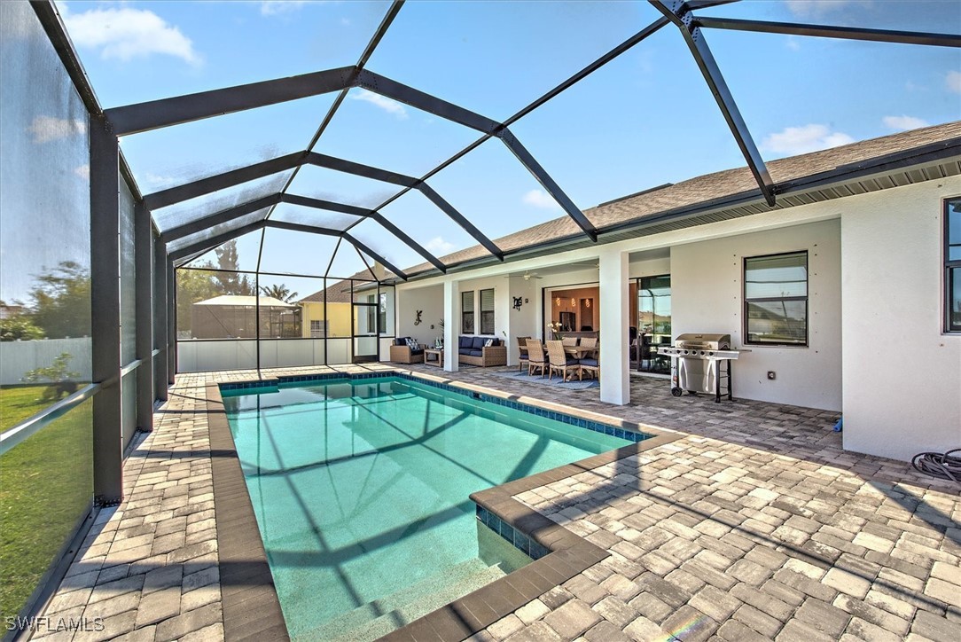 3527 Southwest 4th Lane Cape Coral, FL 33991 - Photo 18 of 18 a backyard of a house with table and chairs