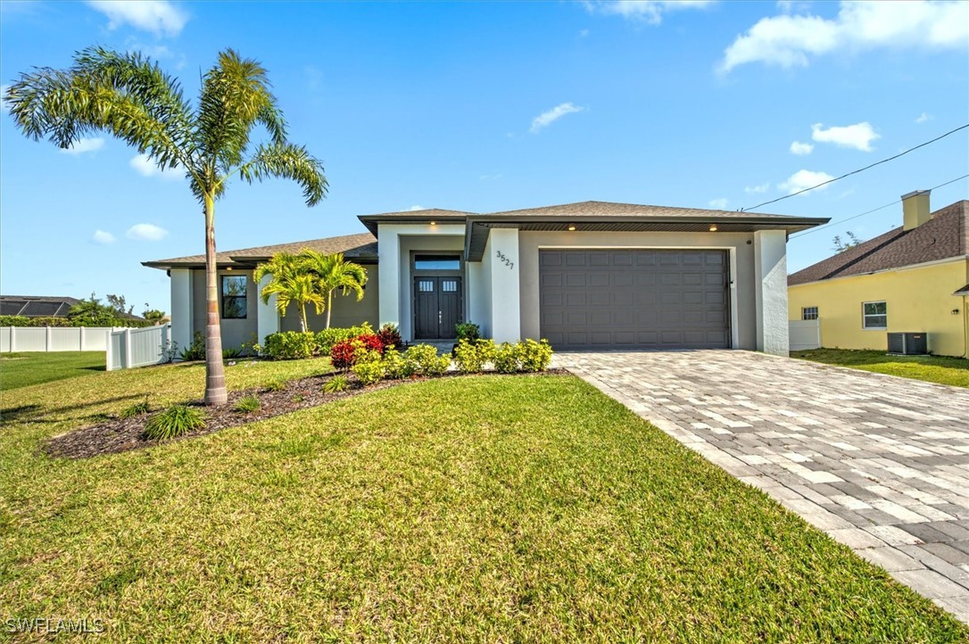 3527 Southwest 4th Lane Cape Coral, FL 33991 - Photo 2 of 18 a view of a house with a backyard and a garden