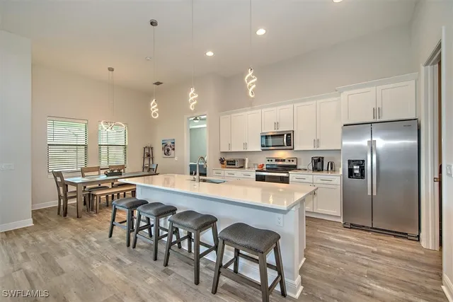 a large kitchen with a table and chairs