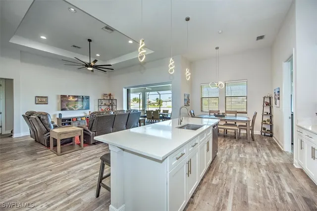a large white kitchen with a table and chairs
