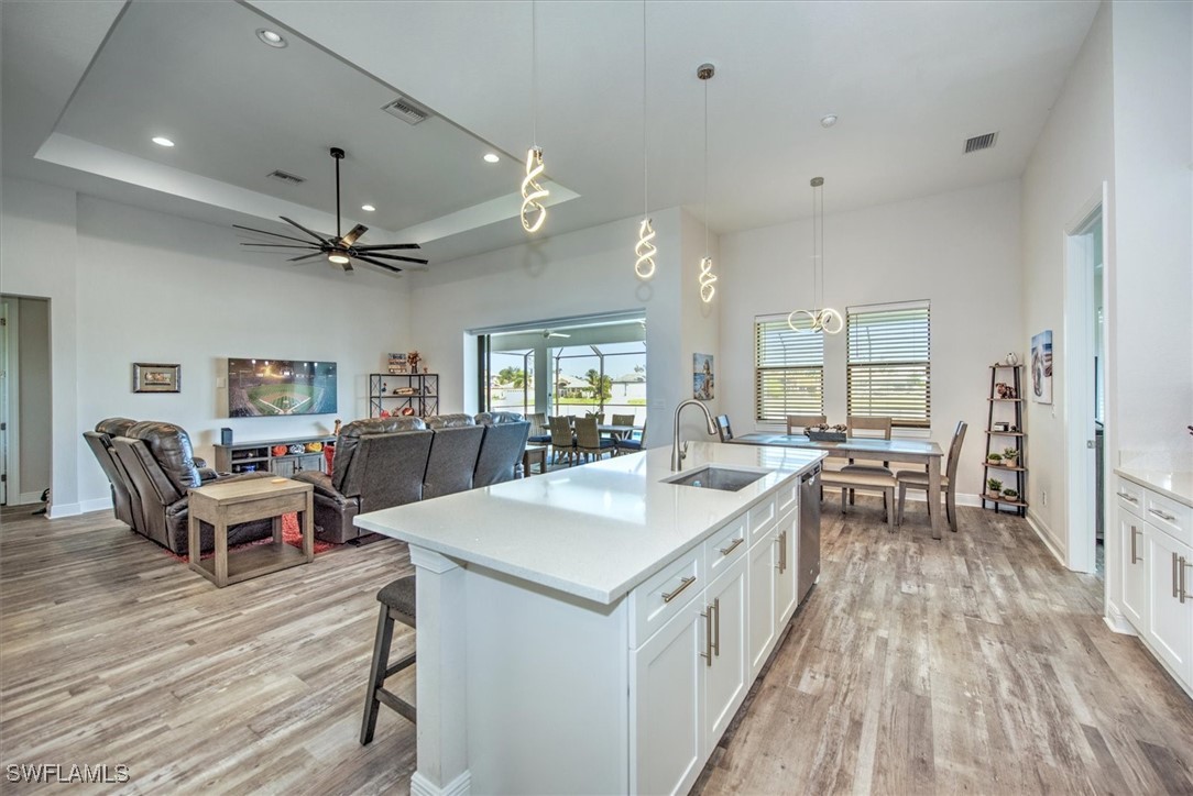 3527 Southwest 4th Lane Cape Coral, FL 33991 - Photo 5 of 18 a large white kitchen with a table and chairs