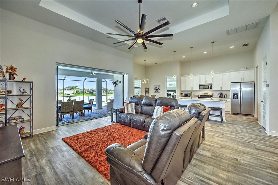 3527 Southwest 4th Lane Cape Coral, FL 33991 - Photo 7 of 18 a living room with furniture kitchen view and a wooden floor