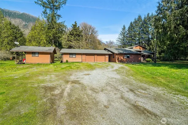 a view of a house with a yard porch and sitting area