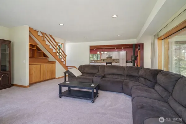 a living room with furniture and a ceiling fan