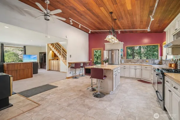 a open kitchen with a sink a counter space dining table and chairs