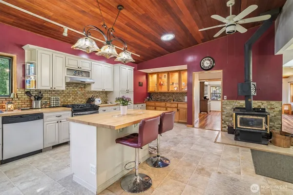 a kitchen with a stove a sink and a refrigerator