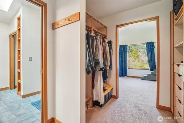 a view of a hallway with closet and furniture