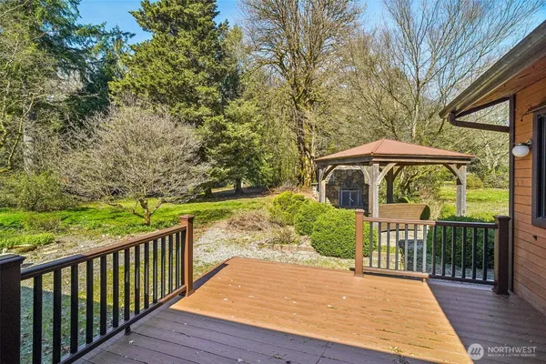 a view of a wooden deck next to a yard