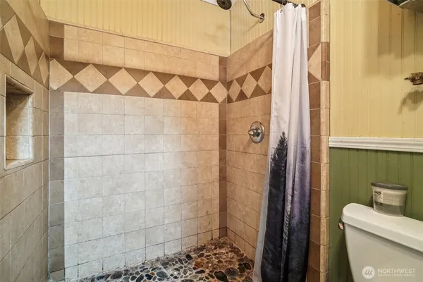 a bathroom with a shower and a toilet