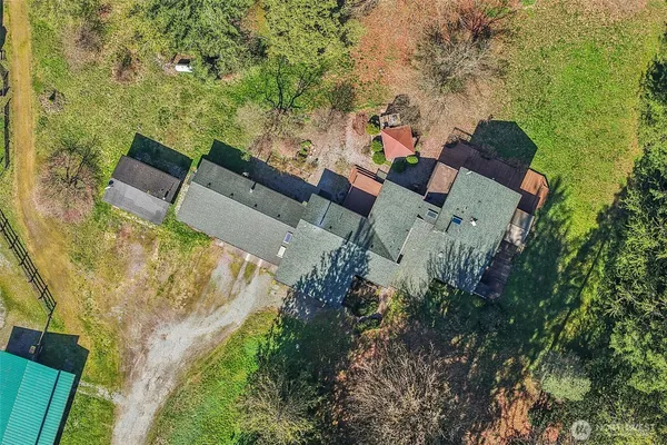 an aerial view of a house with a yard