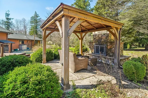 a view of house with backyard porch and sitting area