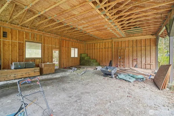 a living room with furniture and large windows