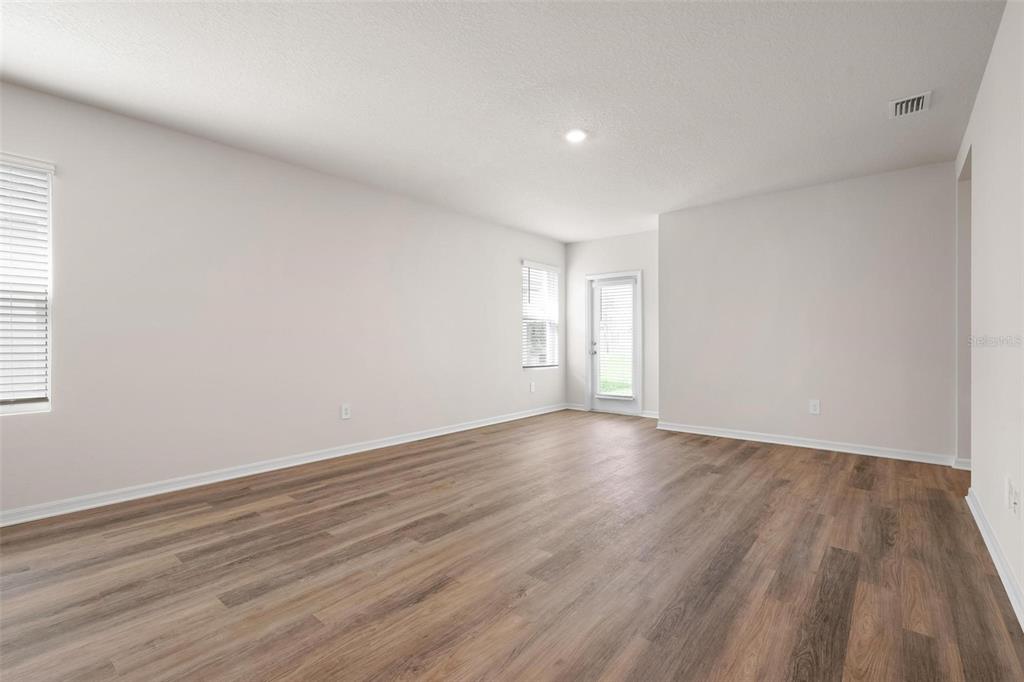 3218 Bitterroot Lane Bradenton, FL 34211 - Photo 11 of 48 a view of an empty room and wooden floor