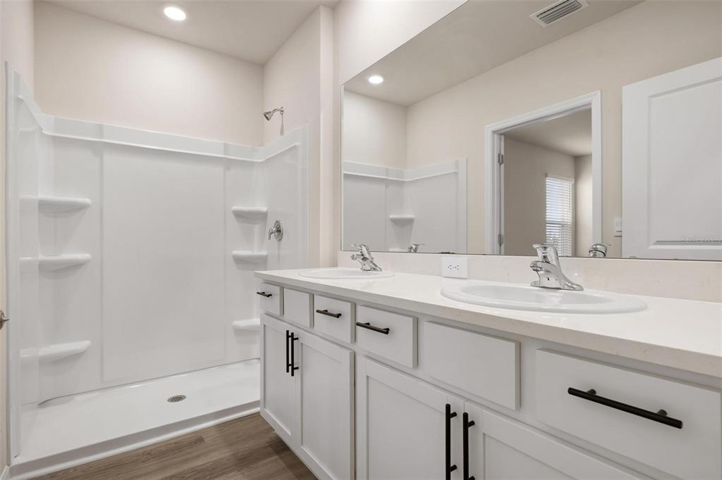 3218 Bitterroot Lane Bradenton, FL 34211 - Photo 18 of 48 a bathroom with a sink a mirror and a shower