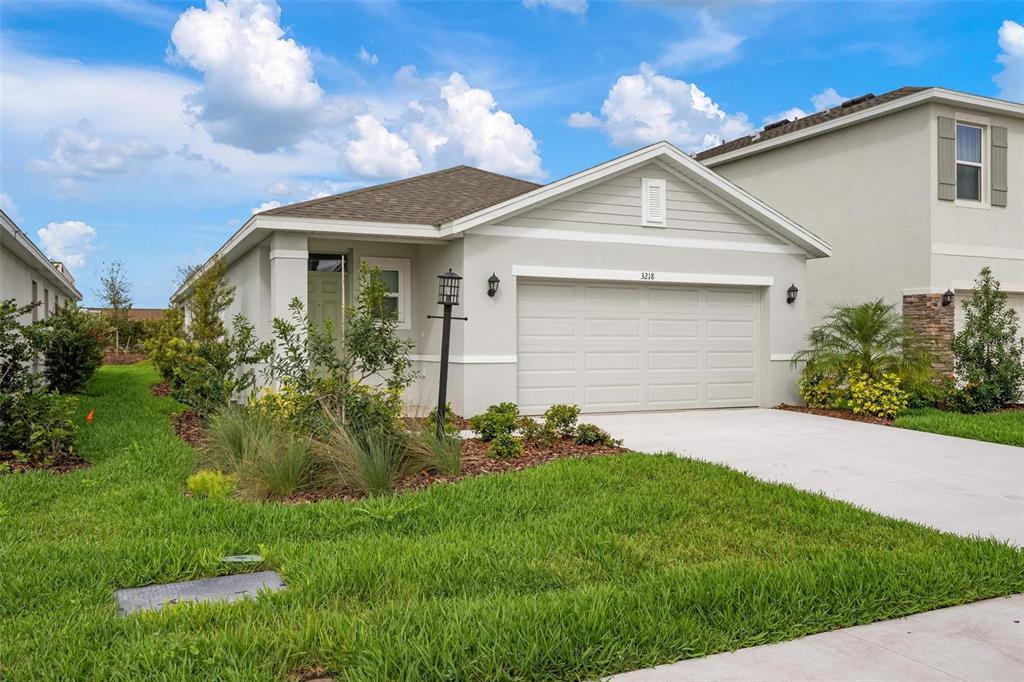 3218 Bitterroot Lane Bradenton, FL 34211 - Photo 2 of 48 a front view of house with a garden