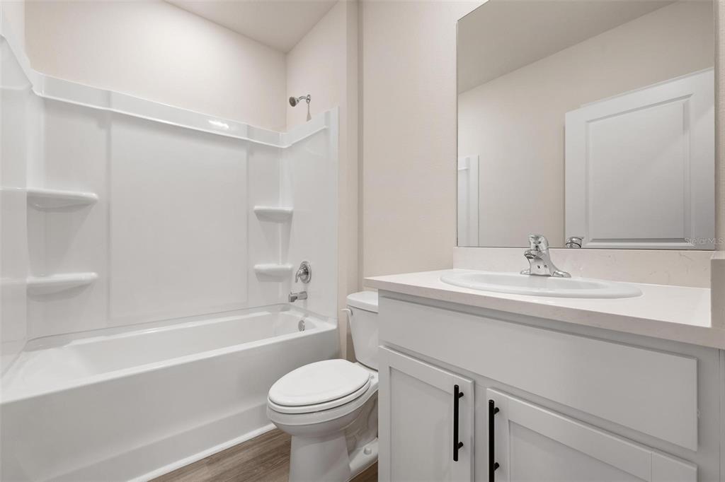 3218 Bitterroot Lane Bradenton, FL 34211 - Photo 22 of 48 a bathroom with a sink a toilet and a bathtub