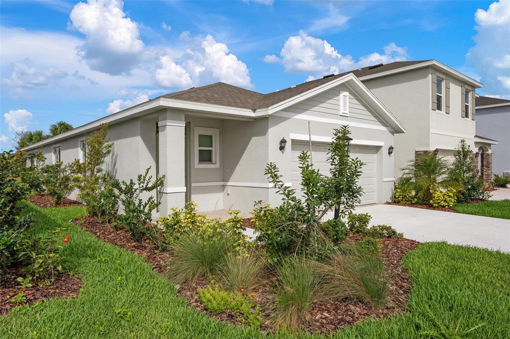 3218 Bitterroot Lane Bradenton, FL 34211 - Photo 28 of 48 a front view of a house with garden