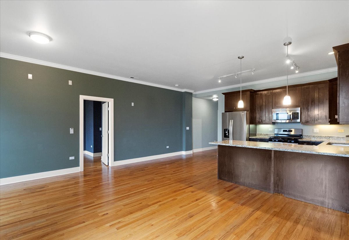 207 East 31st Street, Unit 5B Chicago, IL 60616 - Photo 3 of 10 a view of kitchen with sink and wooden floor