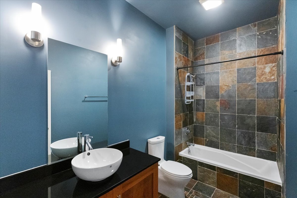 207 East 31st Street, Unit 5B Chicago, IL 60616 - Photo 6 of 10 a bathroom with a sink toilet and shower