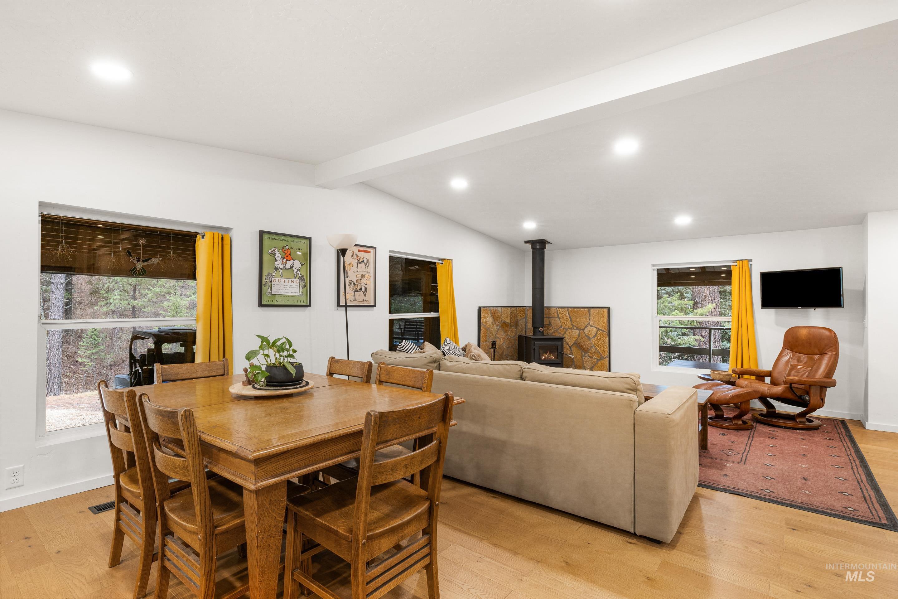 32 Sky Ridge Drive Garden Valley, ID 83622 - Photo 12 of 37 Dining room with a wood stove, light wood finished floors, recessed lighting, and vaulted ceiling with beams