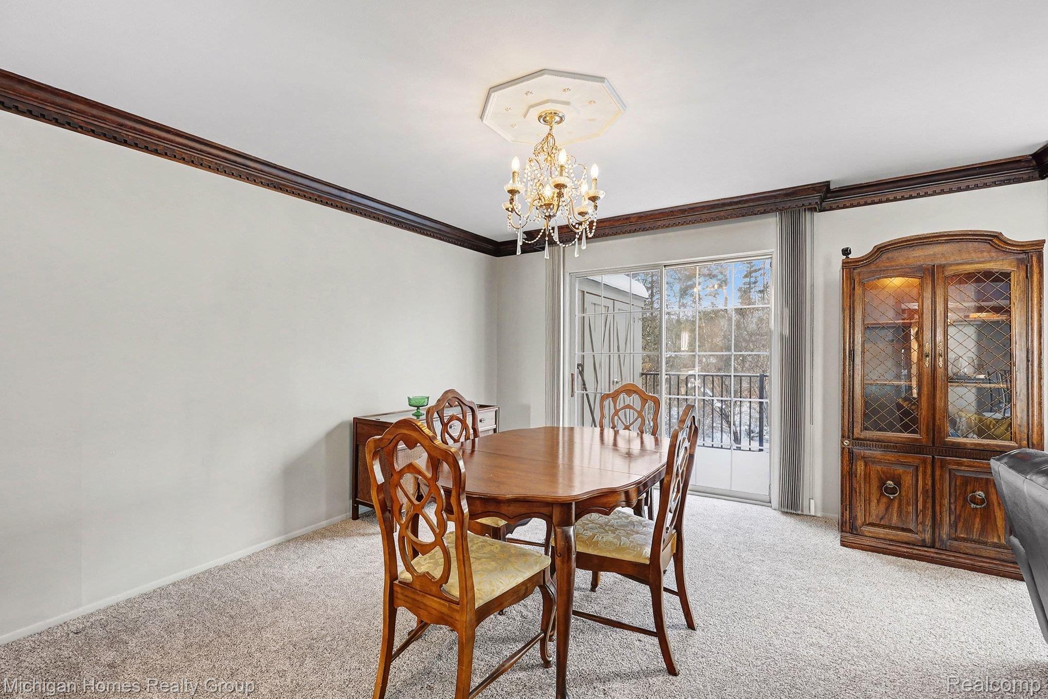1437 Lantern Lane Rochester, MI 48306 - Photo 16 of 31 Dining room featuring light colored carpet, a chandelier, and crown molding