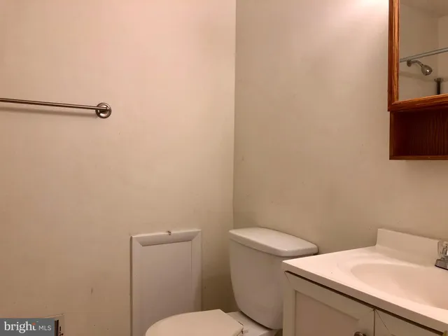 a white toilet sitting next to a bathroom sink