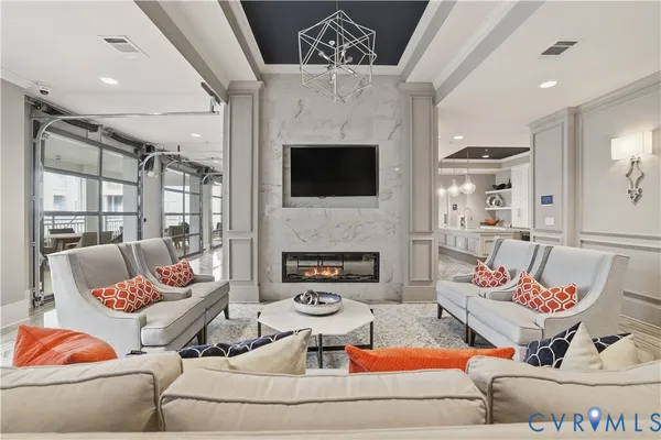 a living room with patio furniture and a flat screen tv