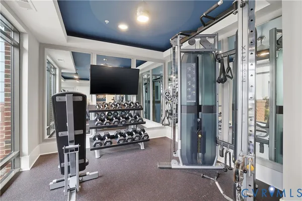 a living room with lots of furniture and a chandelier